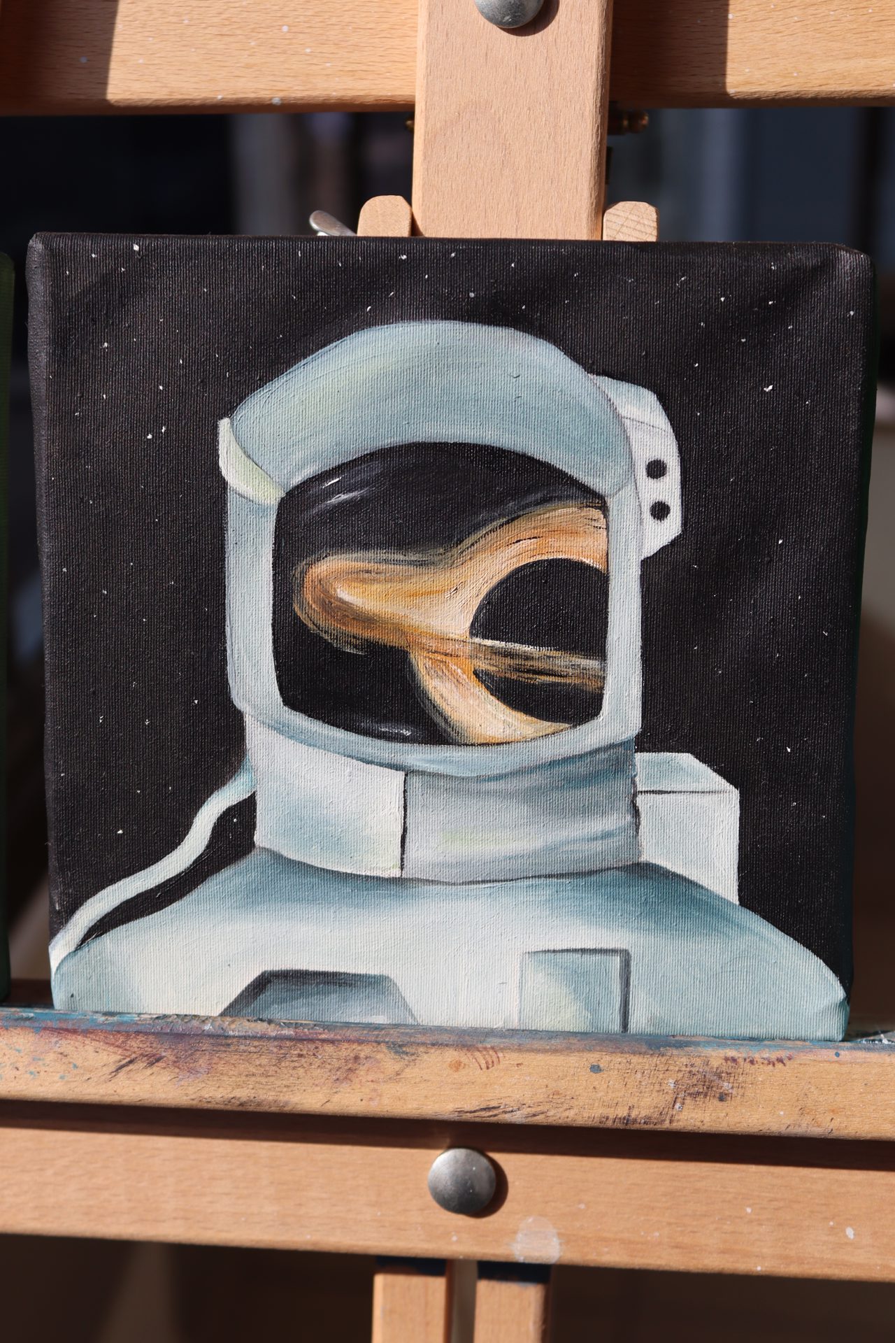 Stardust Astronaut Mini Oil Painting — An astronaut in starry space with a golden nebula reflected in the visor