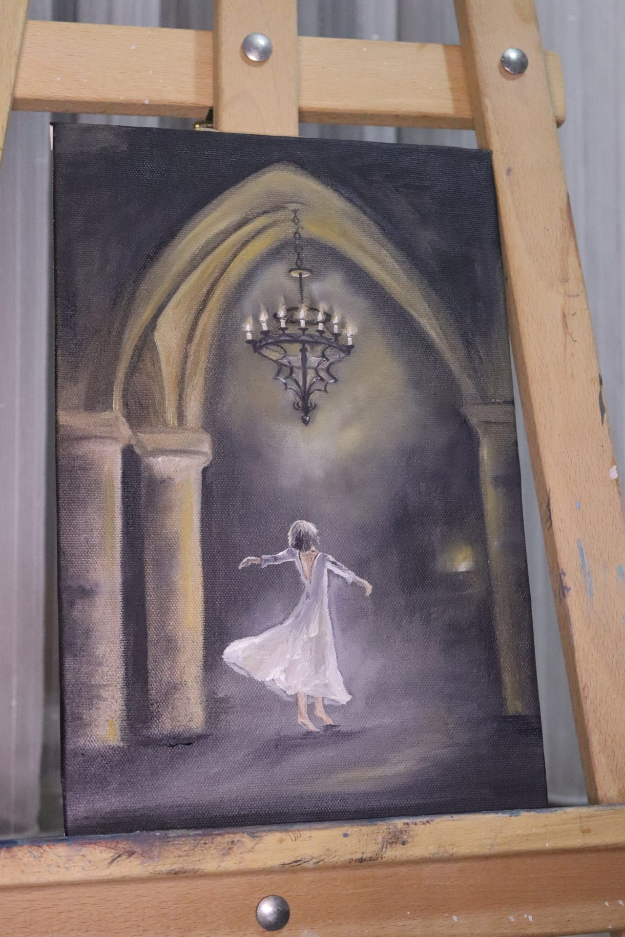 Ballerina in the Gothic Hall Oil Painting — A barefoot ballerina in a white dress twirls beneath a candlelit chandelier in a misty Gothic hall