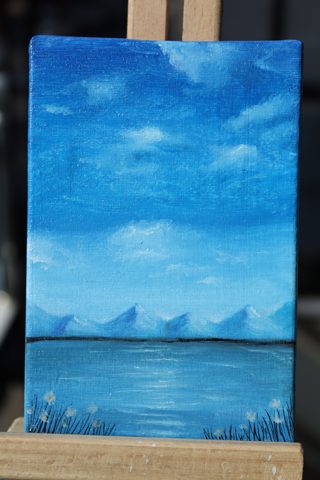 Blue Mountain Lake Mini Landscape Oil Painting — A calm lake below distant mountains under a blue sky, wildflowers along the shore